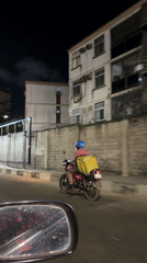 Glovo delivery rider spotted on nighttime street in Ikoyi
