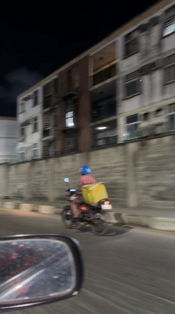 Glovo delivery rider spotted on nighttime street in Ikoyi