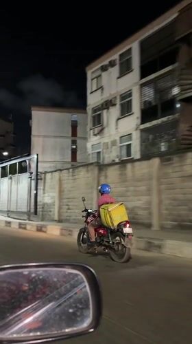 Glovo delivery rider spotted on nighttime street in Ikoyi