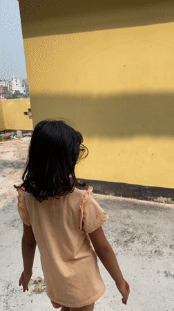Morning rooftop scenes capture children playing in Dhaka