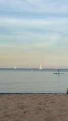 Quiet afternoon on a Barcelona beach, sails and paddleboard in view