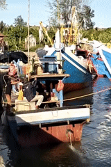 Colorful fishing boats docked in calm Lhokseumawe waters