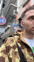 Pierced young man walks Buenos Aires street scene