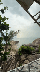 Rainbow arcs over Thai beach in Ban Tai Subdistrict