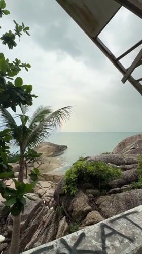 Rainbow arcs over Thai beach in Ban Tai Subdistrict