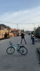 Roller skater performs bicycle jumps on residential street in Lekki