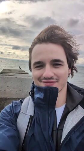 Man films selfies at Odesa pier during early morning