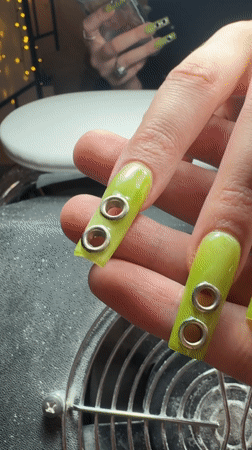 Belgrade resident shows off lime green nails with silver accents