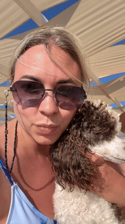 Woman documents lazy beach day with poodle in Anapa