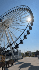 Ferris wheel filmed in bright afternoon sun in Puebla