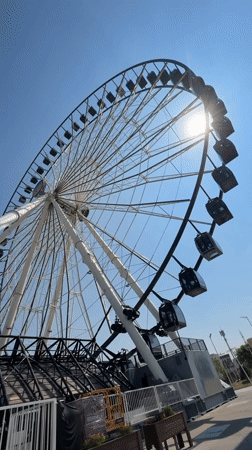 Ferris wheel filmed in bright afternoon sun in Puebla