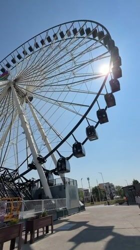 Ferris wheel filmed in bright afternoon sun in Puebla