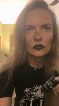 Woman applies makeup with gothic styling in Cape Coral