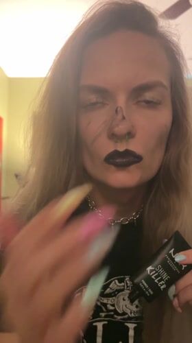 Woman applies makeup with gothic styling in Cape Coral