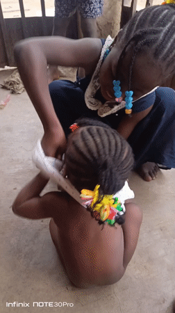 Children at rest on concrete floor in Akwanga