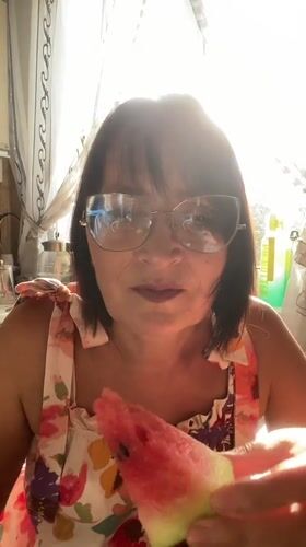 Cutting and eating fresh watermelon in a sunny Novokuznetsk kitchen