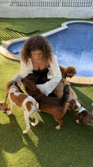 Woman plays with multiple dogs in Kediri backyard