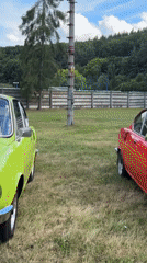 Classic car show with vintage vehicles and folk dancers