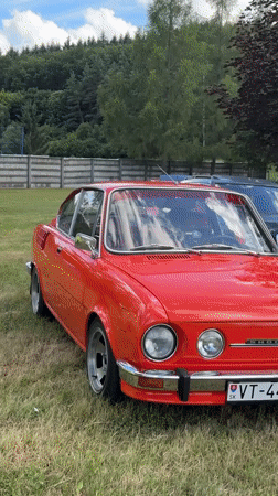 Classic car show with vintage vehicles and folk dancers