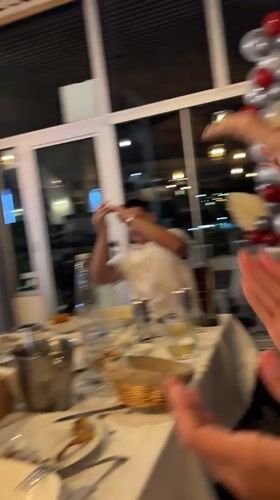 Group celebrates at restaurant table in Sozopol, Bulgaria