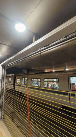 Sofia metro train arrives at a tiled underground platform