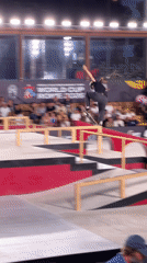 Nighttime skate competition with tricks, falls, and a packed crowd
