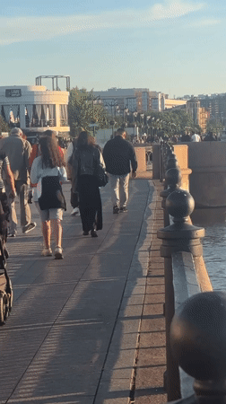 Astrakhan waterfront buzzes with families, music, boats on sunny afternoon