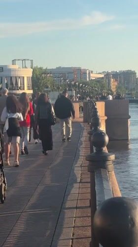 Astrakhan waterfront buzzes with families, music, boats on sunny afternoon