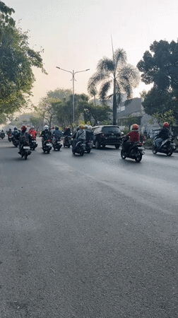 Rush-hour motorcycle traffic on a busy road in Gelam, Indonesia
