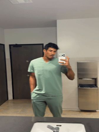 Man in scrubs takes selfie in El Segundo restroom