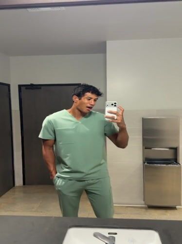 Man in scrubs takes selfie in El Segundo restroom