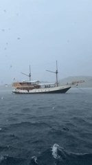 Traditional schooner weathers heavy rain in Indonesian waters
