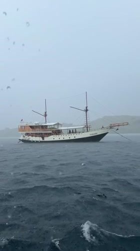 Traditional schooner weathers heavy rain in Indonesian waters