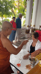 Woman receives traditional Buddhist blessings at Thai temples