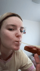 Woman enjoys sandwich meal in Yanino-1 bedroom