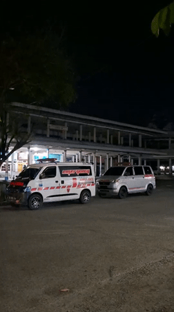 Two vans parked at night in Sigli, Indonesia