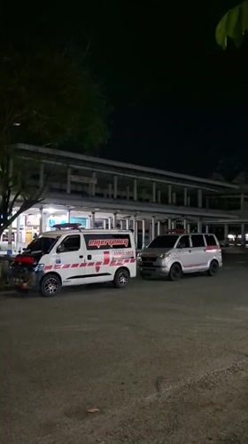 Two vans parked at night in Sigli, Indonesia