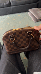 Person Opens Louis Vuitton Handbag in London