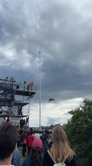 Diver performs aerial stunts from tall platform in Copenhagen