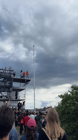 Diver performs aerial stunts from tall platform in Copenhagen
