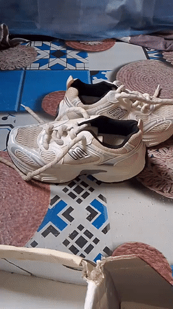 Athletic shoes displayed on patterned surface in Gumel, Nigeria