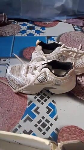Athletic shoes displayed on patterned surface in Gumel, Nigeria