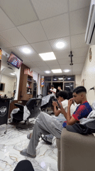 Young men wait with phones at Safi barbershop