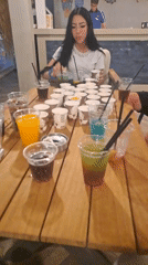 Woman at table with drinks in Kuşadası venue