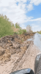Road blocked by mud pile in Omsk following rain