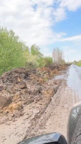 Road blocked by mud pile in Omsk following rain