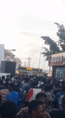 Outdoor event with championship belts and '9ja' banners in Ikeja