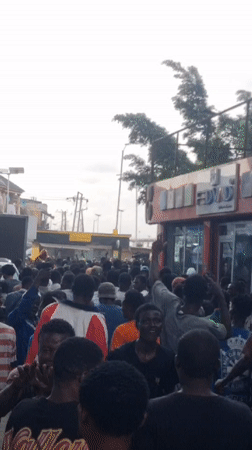 Outdoor event with championship belts and '9ja' banners in Ikeja