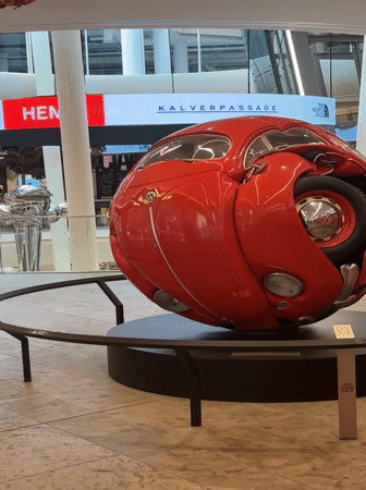 Spherical Volkswagen Beetle sculpture on display indoors