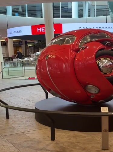 Spherical Volkswagen Beetle sculpture on display indoors